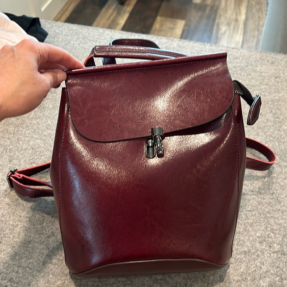 Super cute, genuine, leather, deep, red backpack purse can also be Crossbody